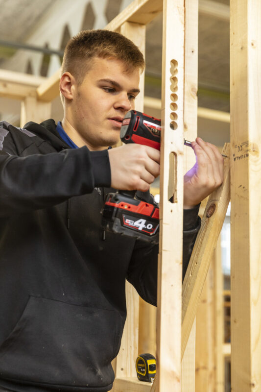Construction student using drill Tresham College