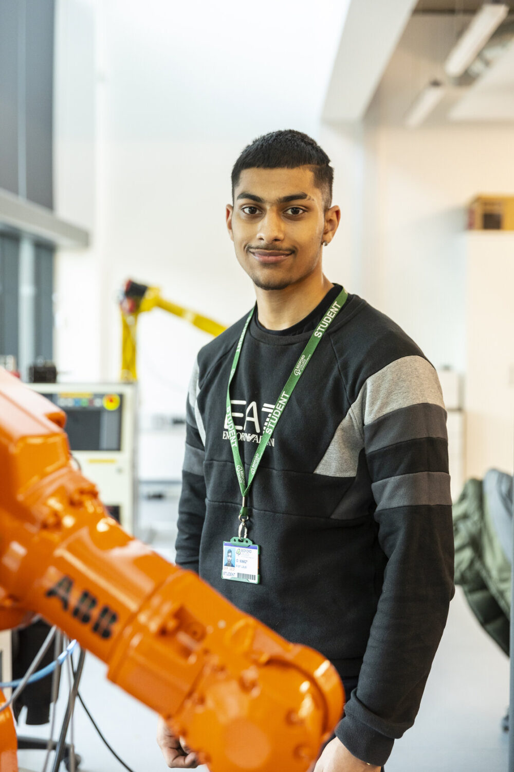 Engineering student with robotic arm Bedford College