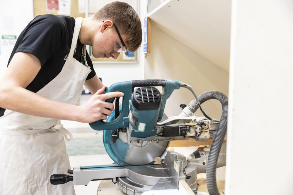Construction student using machinery Tresham College